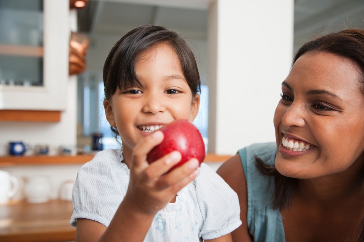 Image of a girl holding an apple